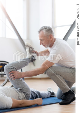 Powerful orthopedist stretching the handicapped in 28269201