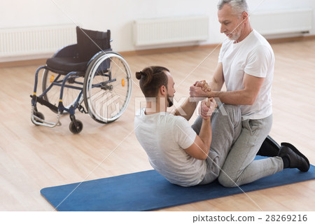 Skilled orthopedist assisting the disabled in the Skilled orthopedist assisting the disabled in the 28269216