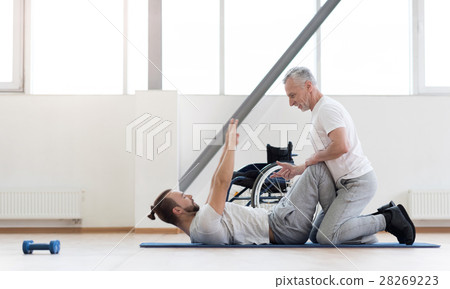 Experienced positive orthopedist assisting the Experienced positive orthopedist assisting the 28269223