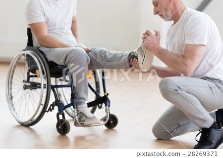 Aged orthopedist working with handicapped in the 28269371