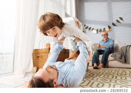 Delighted nice father man holding his son 28269532