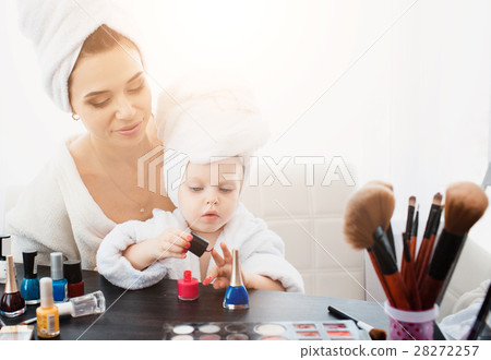Beautiful woman and her daughter making manicure 28272257
