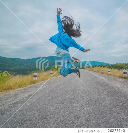 Beautiful girl jumping on the rural road Beautiful girl jumping on the rural road 28278640