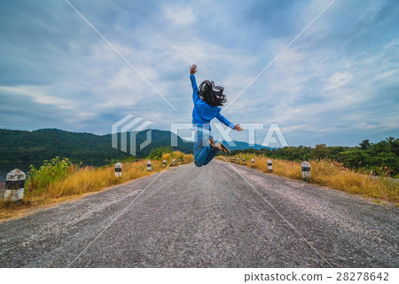Beautiful girl jumping on the rural road Beautiful girl jumping on the rural road 28278642