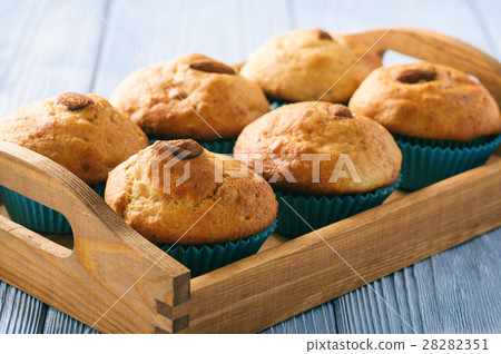 Sweet muffins with almond on blue wooden table. Sweet muffins with almond on blue wooden table. 28282351