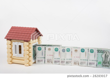 Before the house lined up Russian rubles banknotes of different denomination, white background 28283017