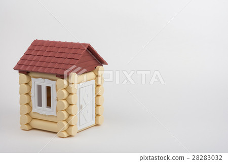 Toy house on a white background, near a place under an inscription Toy house on a white background, near a place under an inscription 28283032