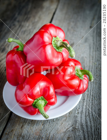 Red bell peppers on the wooden background 28285190