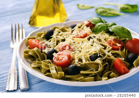 Spinach green pasta with olives, tomatoes, cheese Spinach green pasta with olives, tomatoes, cheese 28285440