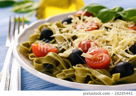 Spinach green pasta with olives, tomatoes, cheese Spinach green pasta with olives, tomatoes, cheese 28285441