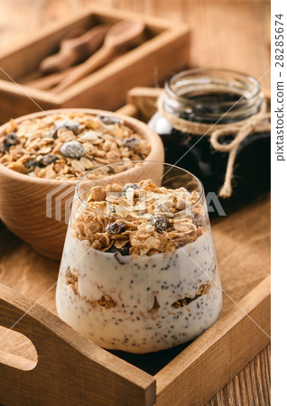Natural yogurt with chia seed, muesli and jam. 28285674