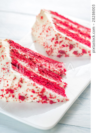 Two slices of red velvet cake on the white plate 28286003