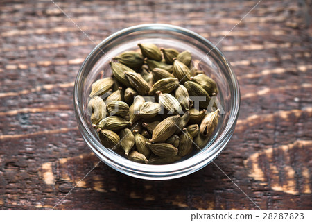 Cordamom seeds in a bowl in the center Cordamom seeds in a bowl in the center 28287823