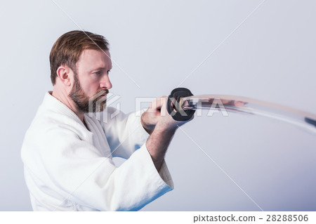 A man with katana on Iaido practice A man with katana on Iaido practice 28288506