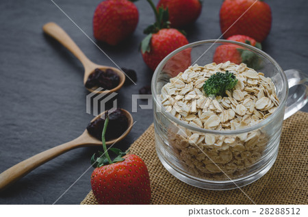 Healthy oatmeal in glass with strawberries 28288512