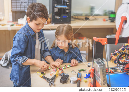 Serious children playing in workshop 28290625