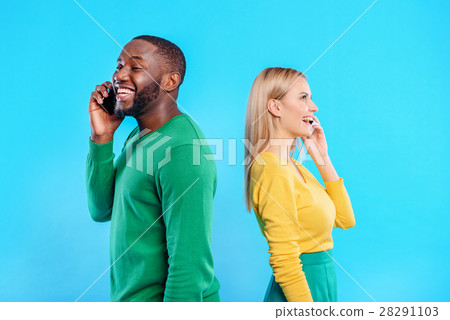 Happy man and woman communicating on smartphones 28291103