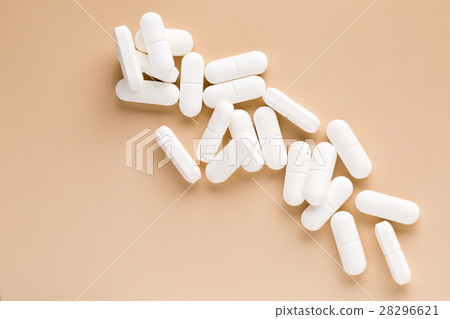 Pile of white pills 28296621
