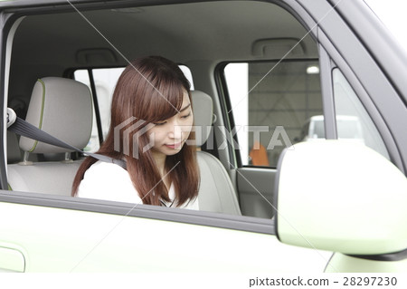 A young woman riding a car A young woman riding a car 28297230