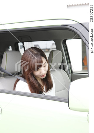 A young woman riding a car A young woman riding a car 28297232