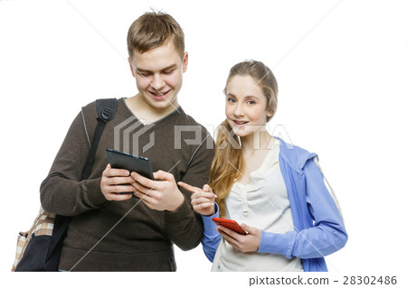 Teen boy and girl standing with mobile phones Teen boy and girl standing with mobile phones 28302486