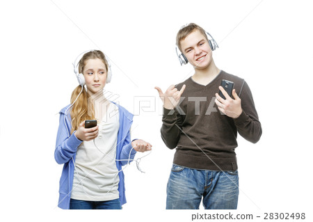 Teen boy and girl with headphones 28302498