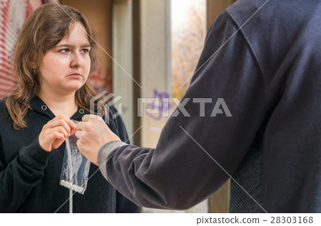 Drug dealer is passing white pills to woman. Drug dealer is passing white pills to woman. 28303168