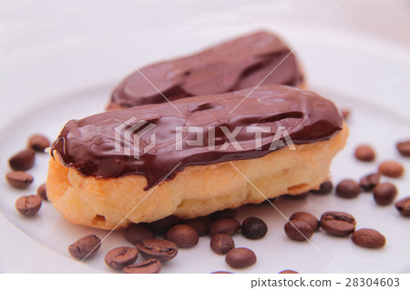 Chocolate eclairs on plate on white background Chocolate eclairs on plate on white background 28304603