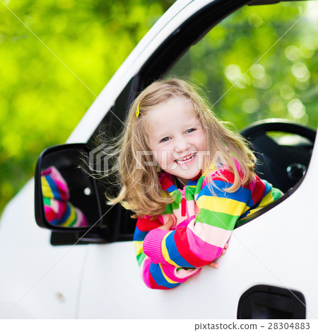 Little girl sitting in white car Little girl sitting in white car 28304883