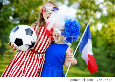 Two funny little sisters supporting and cheering their national football team Two funny little sisters supporting and cheering their national football team 28308648