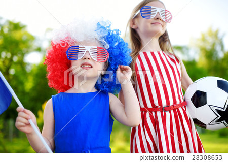 Two funny little sisters supporting and cheering their national football team Two funny little sisters supporting and cheering their national football team 28308653