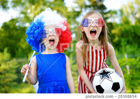 Two funny little sisters supporting and cheering their national football team Two funny little sisters supporting and cheering their national football team 28308654
