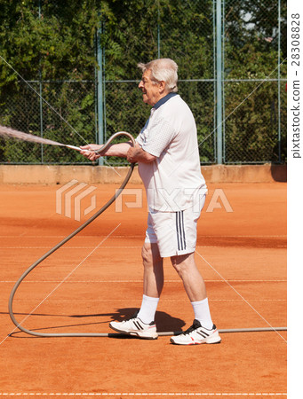 Old men sprinklig tennis court before playing Old men sprinklig tennis court before playing 28308828