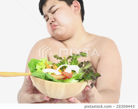 A fat boy hate to eat vegetable salad 28309443