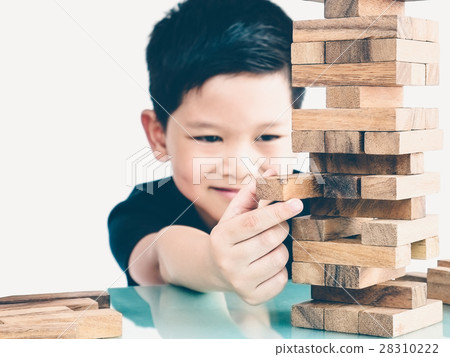 Asian kid is playing wood blocks tower game Asian kid is playing wood blocks tower game 28310222