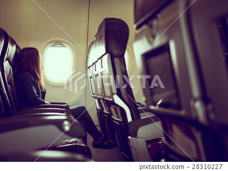 Lady is sitting in airplane Lady is sitting in airplane 28310227