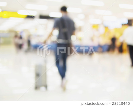 Blurred photo of walking traveler in airport Blurred photo of walking traveler in airport 28310440