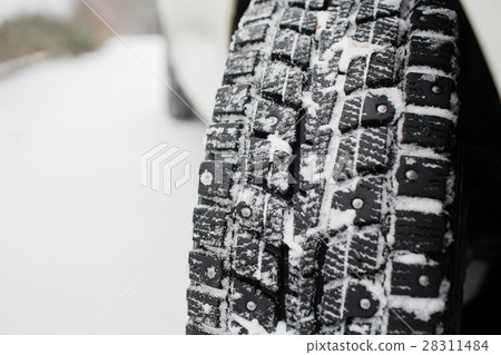 Closeup of car tires in winter. the first snow in Closeup of car tires in winter. the first snow in 28311484
