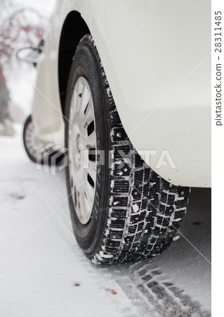 Closeup of car tires in winter. the first snow in 28311485
