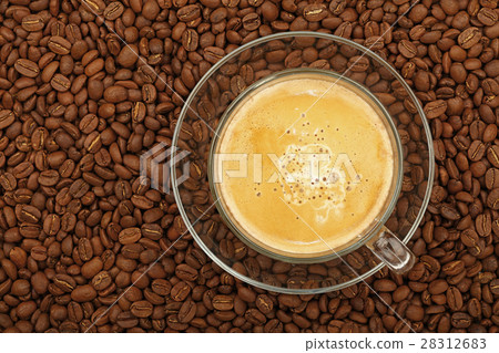 Full latte glass transparent cup on coffee beans 28312683