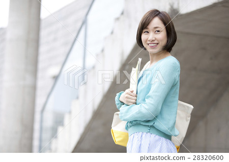 A smiling woman with a book 28320600