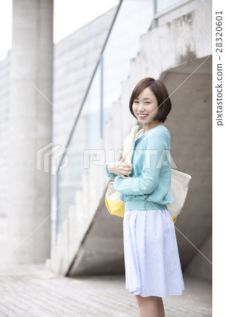 A smiling woman with a book 28320601