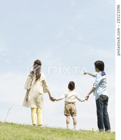 The back of three families holding hands 28321096