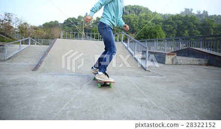 young skateboarder riding skateboard at skatepark young skateboarder riding skateboard at skatepark 28322152
