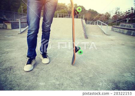 young skateboarder with skateboard at skatepark 28322153