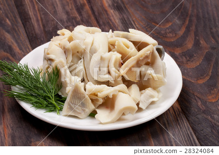 sliced squid on a plate on a dark wooden sliced squid on a plate on a dark wooden 28324084