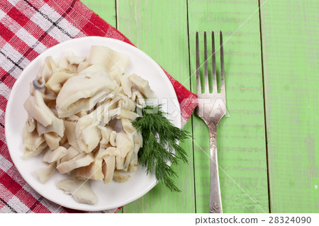 sliced squid on a plate on a green wooden sliced squid on a plate on a green wooden 28324090