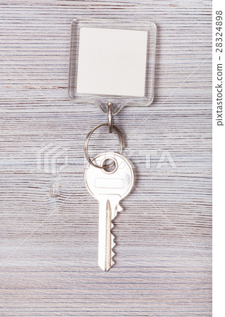 key with white blank keychain on wood board 28324898