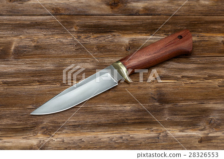 Hunting steel knife handmade on wooden background 28326553