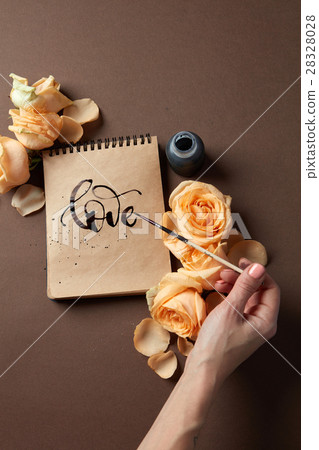 Hand with brush writing a love letter 28328028